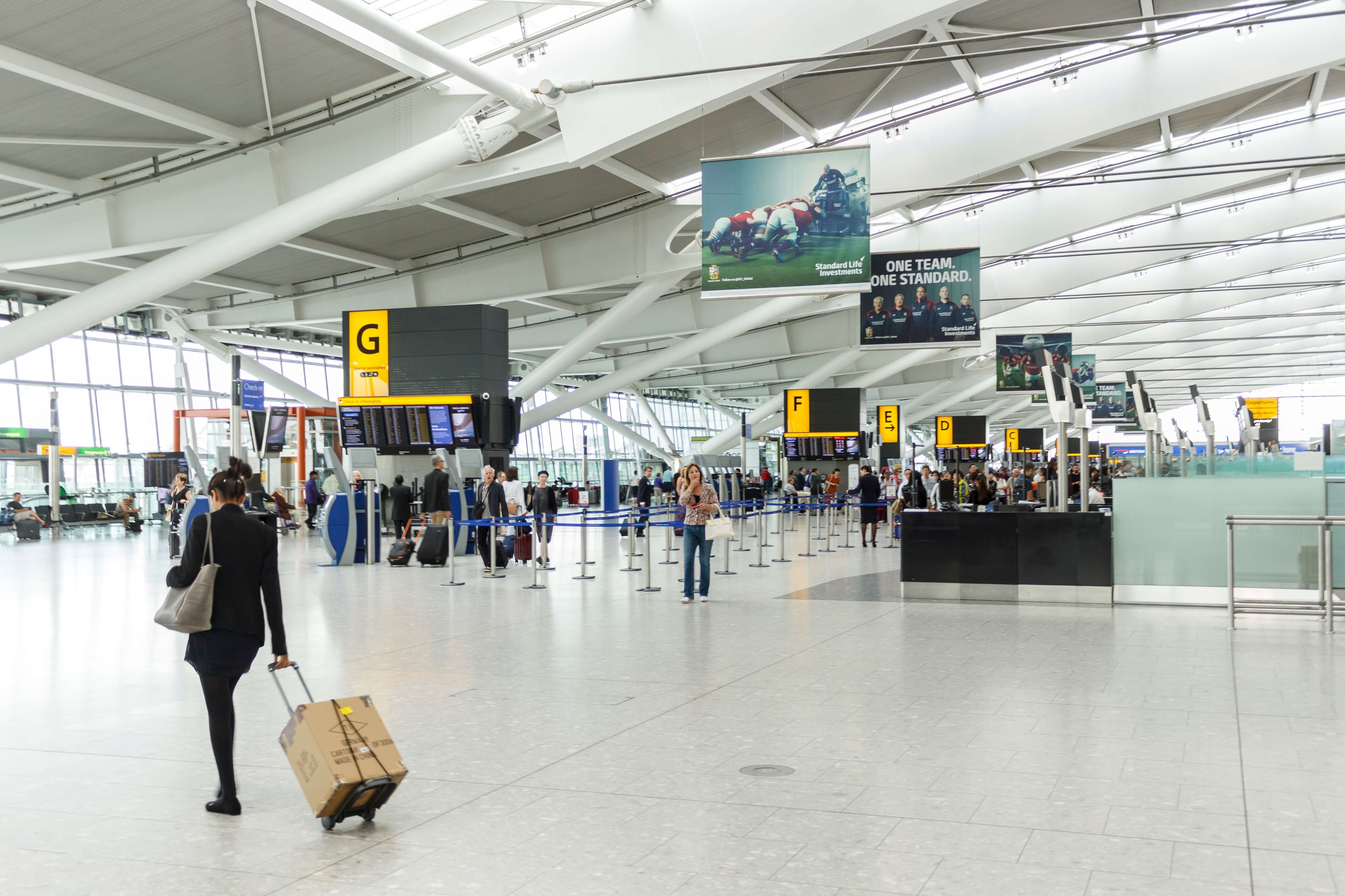 A female passenger arrives for checkin at the departure hall in Terminal 5, Heathrow Airport.